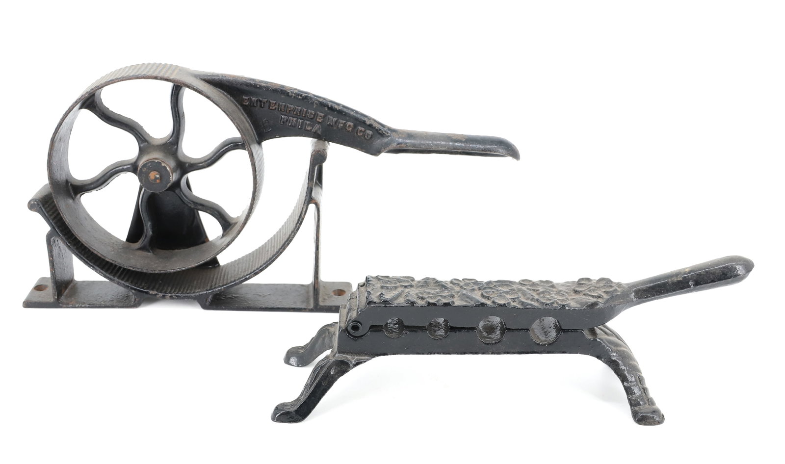(2) ANTIQUE CAST IRON CORK PRESSES: BLACK PAINTED SURFACES. SMALLER HAS EMBOSSED FLORAL DESIGN. 9 1/2" L. WITH, ENTERPRISE NO. 2 CORK PRESS. MRKD. "ENTERPRISE MFG. CO. PHILA" 11 1/2" L. PLEASE READ CAREFULLY - ITEMS MUST BE PAID FOR