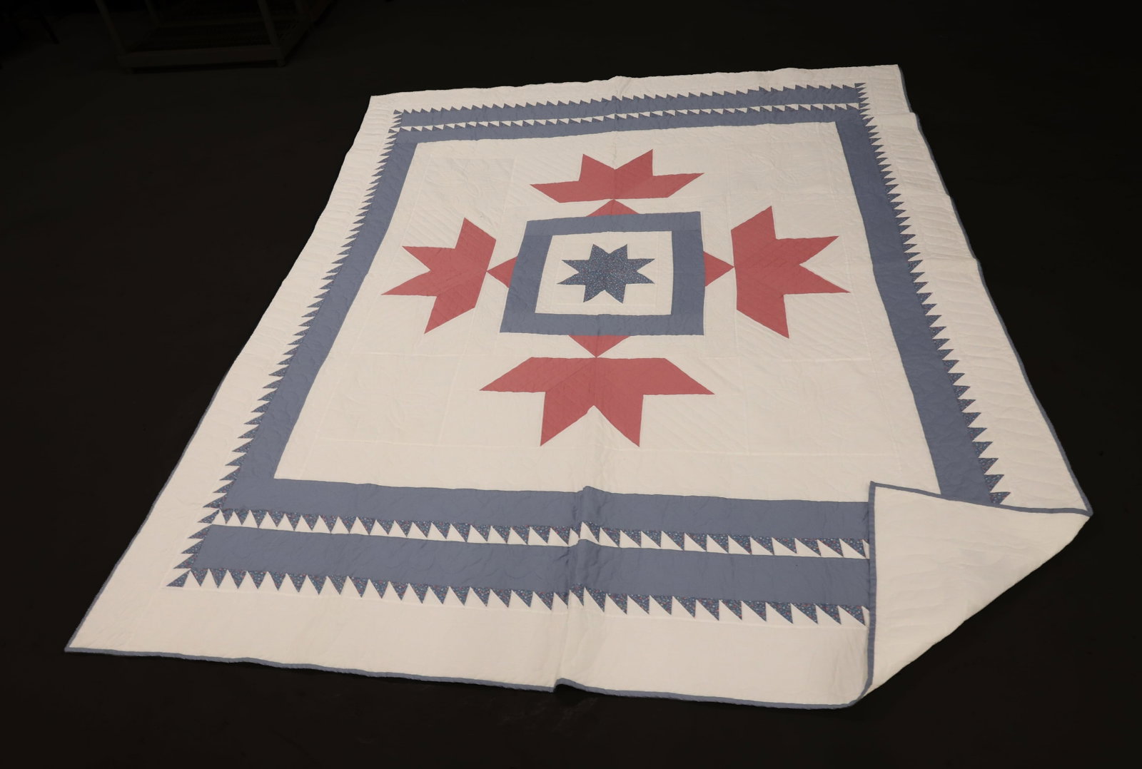 HANDMADE STAR QUILT: LIGHT BLUE AND PINK WITH CENTER EIGHT-POINT STAR. MACHINE SEWN AND HAND STITCHING. 106" X 88". SAWTOOTH BORDER. LOTS OF QUILTING. PLEASE READ CAREFULLY - ITEMS MUST BE PAID FOR THROUGH LIVE AUCTIONEER