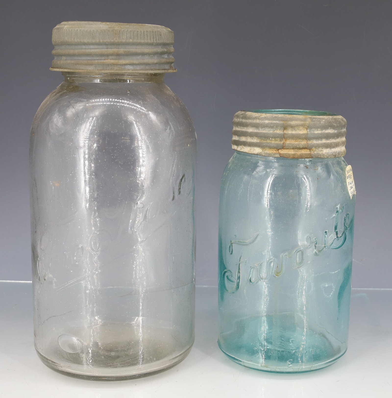 THE ROSE AND "FAVORITE" FRUIT JARS: CLEAR "THE ROSE" WITH GLASS INSERT LID. 9 1/8" TOTAL HEIGHT. WITH, AQUA "FAVORITE, TRADE MARK E" GLASS INSERT LID. 6 7/8" TOTAL HEIGHT. PLEASE READ CAREFULLY - ITEMS MUST BE PAID FOR THROUGH LIVE