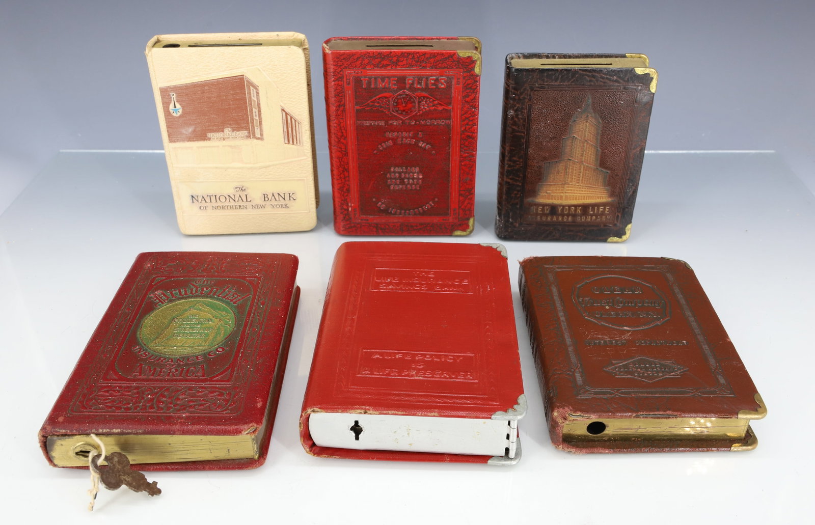 (6) VINTAGE BOOK BANKS: THE PRUDENTIAL. FARMERS & TRADERS NATIONAL BANK, WESTFIELD, PA. THE NATIONAL BANK OF NORTHERN NEW YORK. NEW YORK LIFE INSURANCE. AND MORE. PLEASE READ CAREFULLY - ITEMS MUST BE PAID FOR THROUGH LIVE