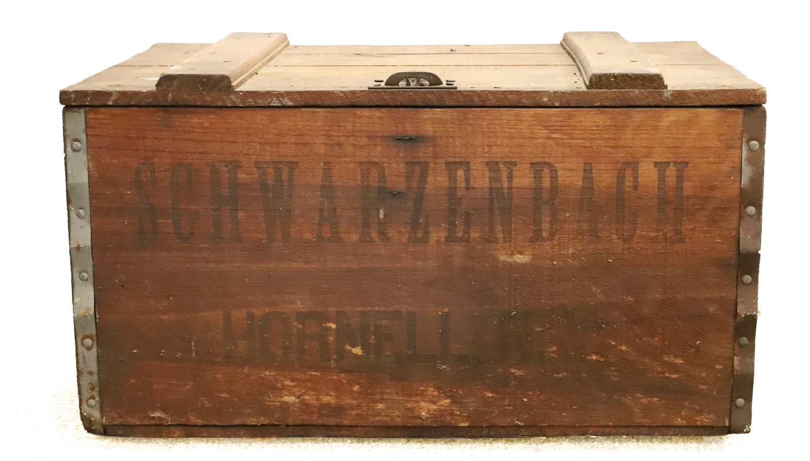 HORNELL, NY ADVERTISING CRATE: WOODEN CRATE W/ HINGED LID "SCHWARZENBACH" ON BOTH SIDES. TRIMMED IN METAL. 20" L. PLEASE READ CAREFULLY - ITEMS MUST BE PAID FOR THROUGH LIVE AUCTIONEERS OR WITH CASH OR CHECK IN PERSON - Terms for P