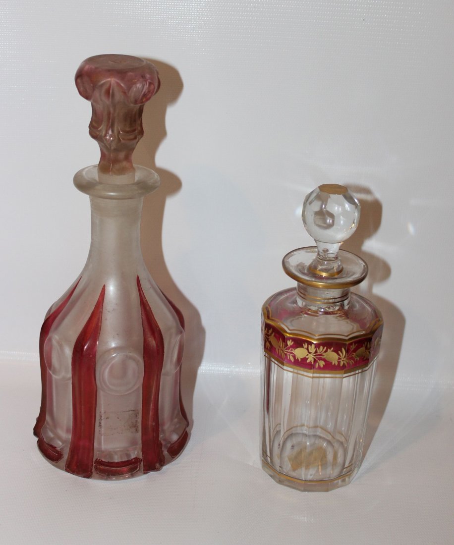 (2) GLASS PERFUME BOTTLES: 1 - PRESSED GLASS MATT FINISH, RUBY STAIN - ONE PANEL CUT INTAGLIO FLOWERS W/ GOLD AND RUBY STAIN 8 5/8" - 6 1/2"