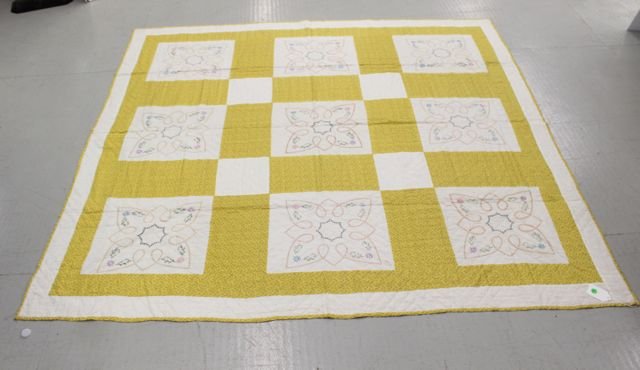 HAND STITCHED QUILT: YELLOW AND WHITE WITH FLORAL DESIGN. CROSS STITCHED AND EMBROIDERED. FRONT YELLOW AND WHITE. 77"x72"