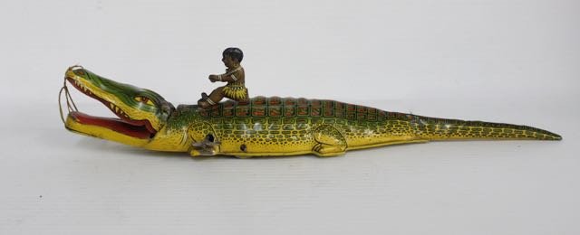 Chein #140 wind-up tin Native on Alligator: Chein Catalog #140 wind up tin Native on Alligator toy 15â€ long x 3â€ wideâ€.