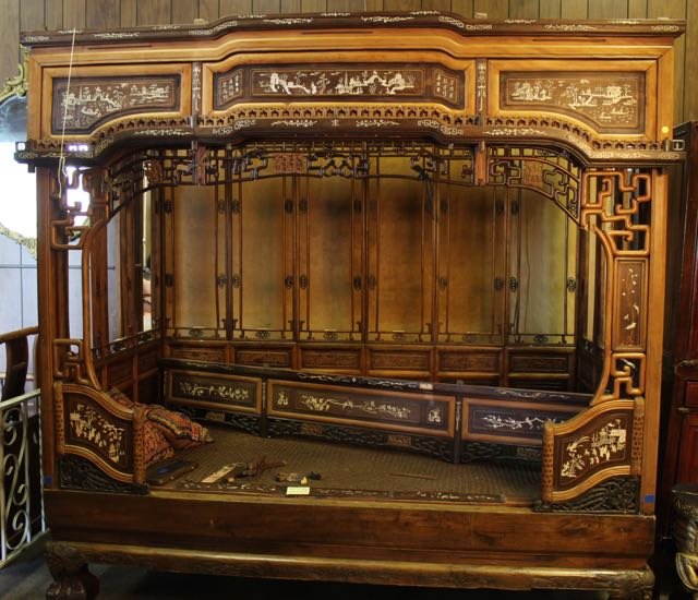 19TH CENTURY OPIUM BED: EARLY CARVED AND INLAID OPIUM BED WITH PANEL SECTIONS OVER RAISED FEET 82"X46"X82"
