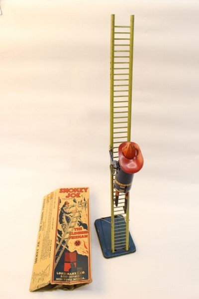 MARX SMOKEY JOE: LOUIS MARX AND CO. SMOKEY JOE (THE CLIMBING FIREMAN) WITH ORIGINAL BOX, MINOR PAINT LOSS TO FIREMAN AND LADDER BOX MISSING FLAPS, IN WORKING ORDER, 23".