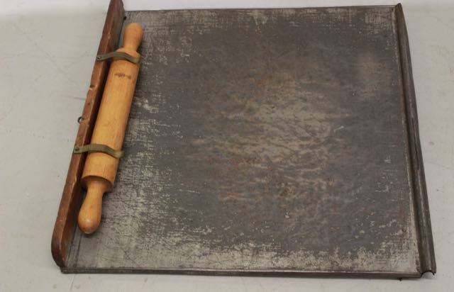TIN DOUGH BOARD: ANTIQUE TIN DOUGH BOARD WITH WOODEN ROLLING PIN. 22" X 20"