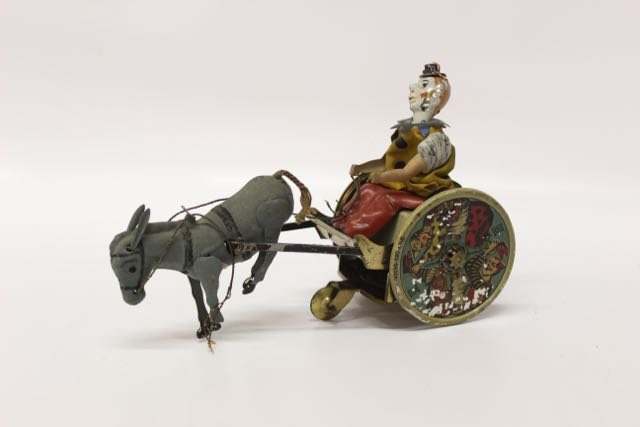 TIN WIND-UP TOY: CLOWN WITH MULE TIN WIND-UP - MADE IN GERMANY BY LEHMANN Dimensions: 5"X8"