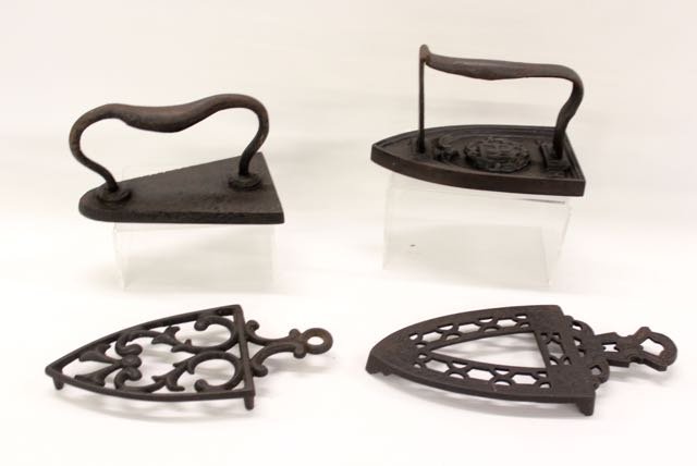 IRON AND TRIVET LOT: PR. FLAT IRONS AND DECORATED TRIVETS - ONE IRON MARKED "MHN 6 " Dimensions:IRONS 6 1/2" AND 7"