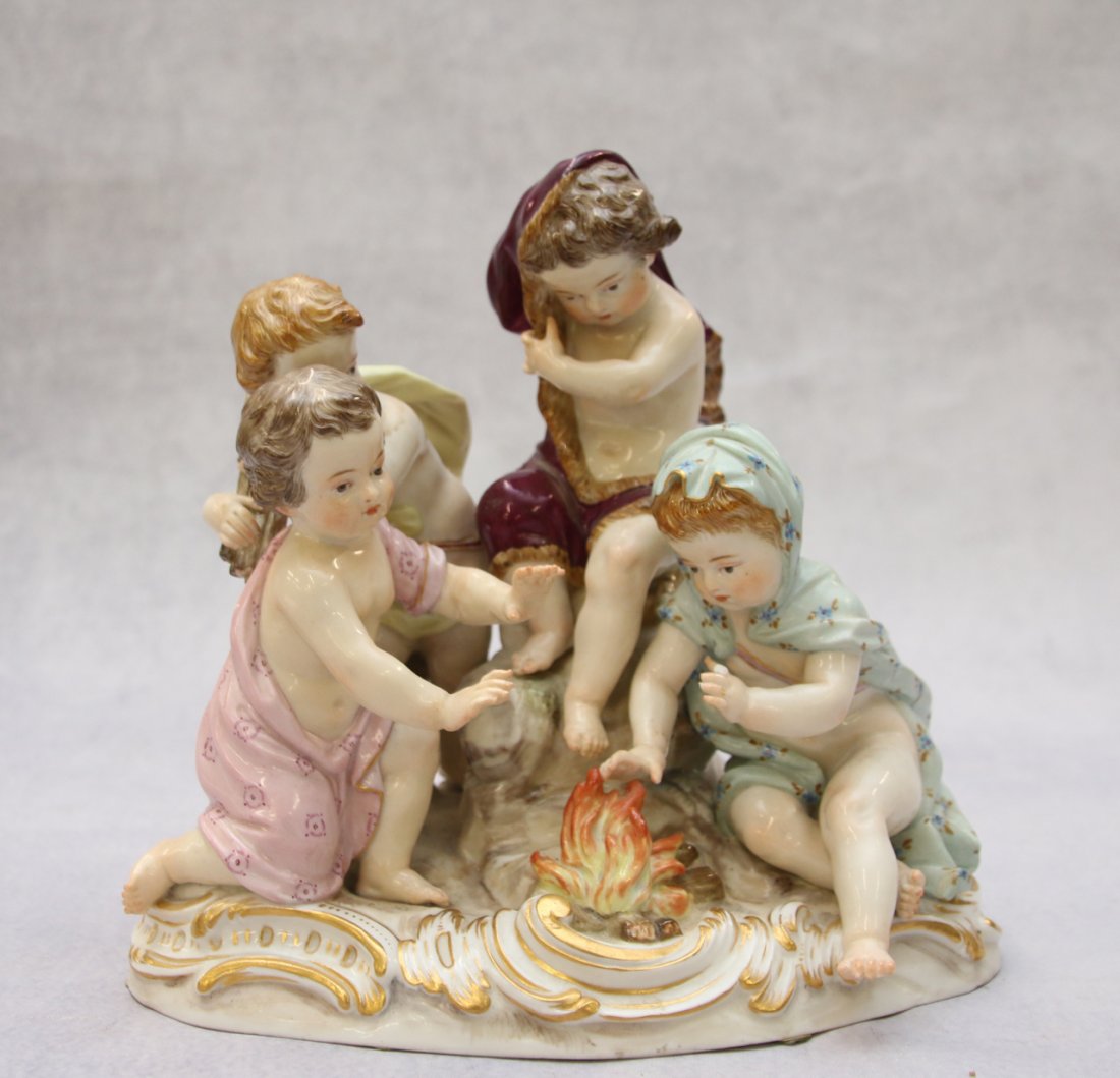 MEISSEN PORCELAIN FIGURE: GROUP OF CHILDREN WITH FIRE - UNDERGLAZE COBALT CROSS SWORD MARK - #42 IMPRESSED - #2495 SCRIPT - #56 ORANGE PAINT 7" X 7 1/2"
