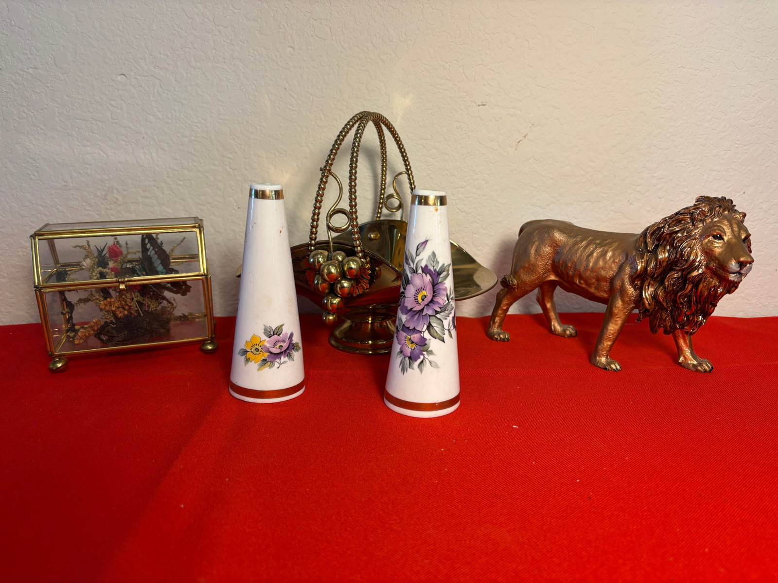 Brass & Goldtone Vintage Displays, 5 Pieces: Goldtone Lion Figure, unmarked. Royal Stuart pr. of Fine Bone China Shakers, Glass & Brass CurioDisplay with Butterfly. (Insect Damaged) and Brass Basket from Italy.
