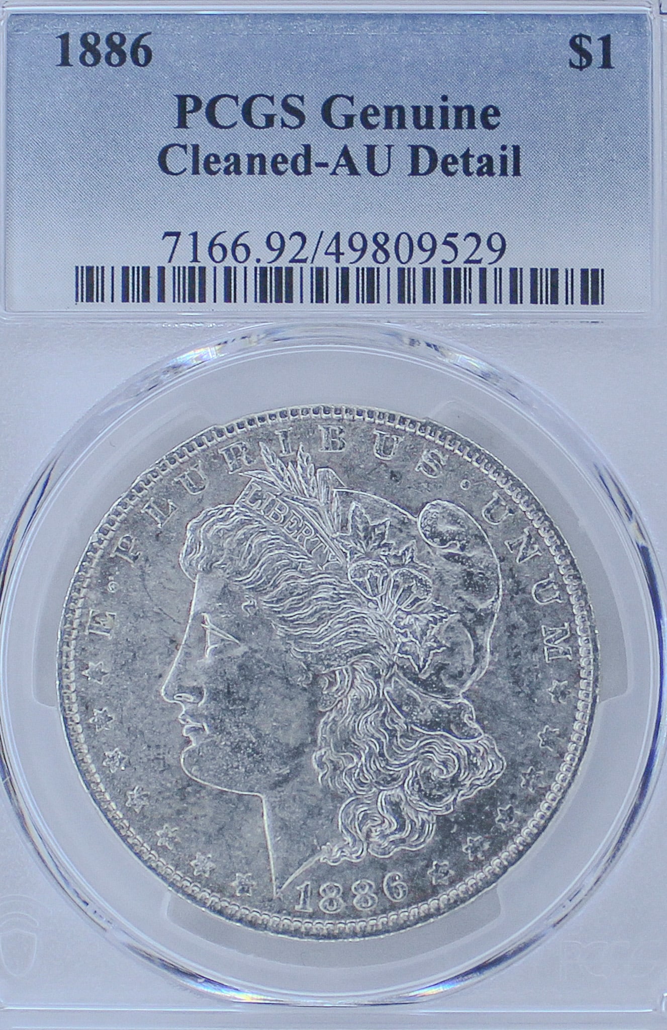 1886 Morgan Silver Dollar Genuine Cleaned-AU Detail: The 1886 Morgan Silver Dollar is a stunning piece of American history and was professionally graded by PCGS, Professional Coin Grading Service, as Genuine Cleaned-AU Detail.