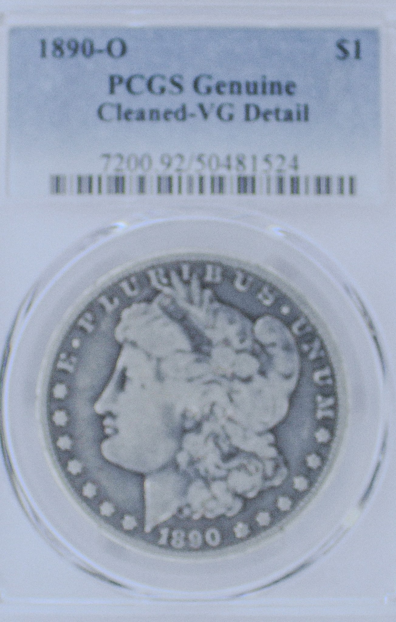 1890-O Morgan Silver Dollar Genuine Cleaned-VG Detail: The 1890-O Morgan Silver Dollar is a stunning piece of American history and was professionally graded by PCGS, Professional Coin Grading Service, as Genuine Cleaned-VG Detail.
