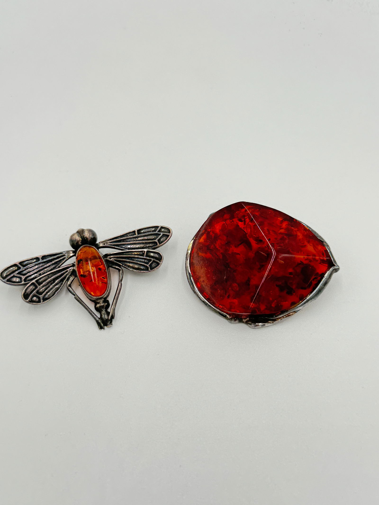 Two amazing sterling silver amber brooches: Offered here is two amazing sterling silver amber brooches. 1.5" and 1"long. Marked on the back. SEE PICTURES FOR MORE DETAIL AS THEY ARE THE BEST DESCRIPTION. WE PROVIDE IN-HOUSE/COMBINED SHIPPING FO