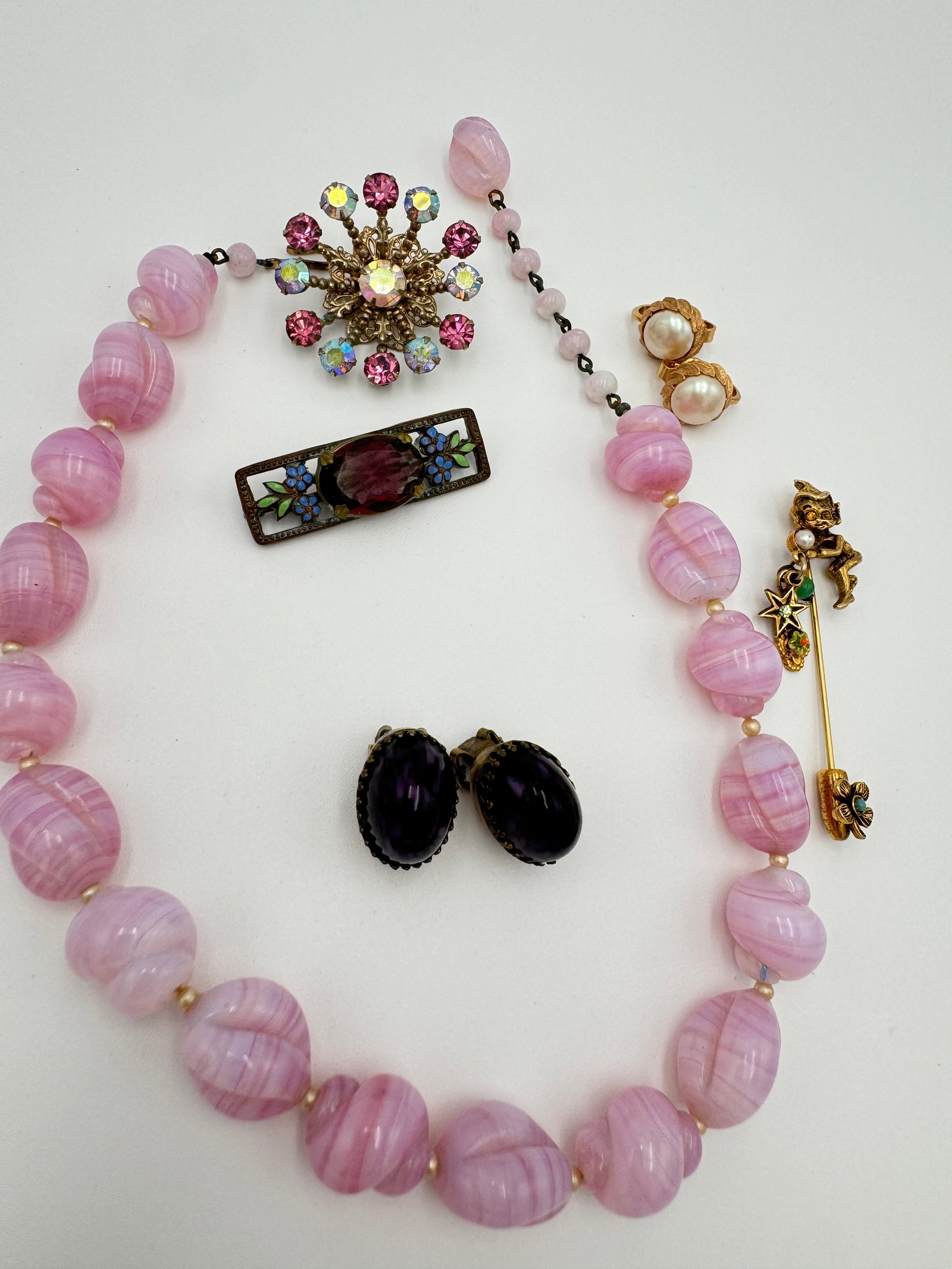 Beautiful pink glass vintage necklace, trifari signed earrings and more: Beautiful pink glass vintage necklace, trifari signed earrings , stick pin, nice clip on usual earrings, brooches. Good vintage condition. See pictures for more details as they are the best descriptio