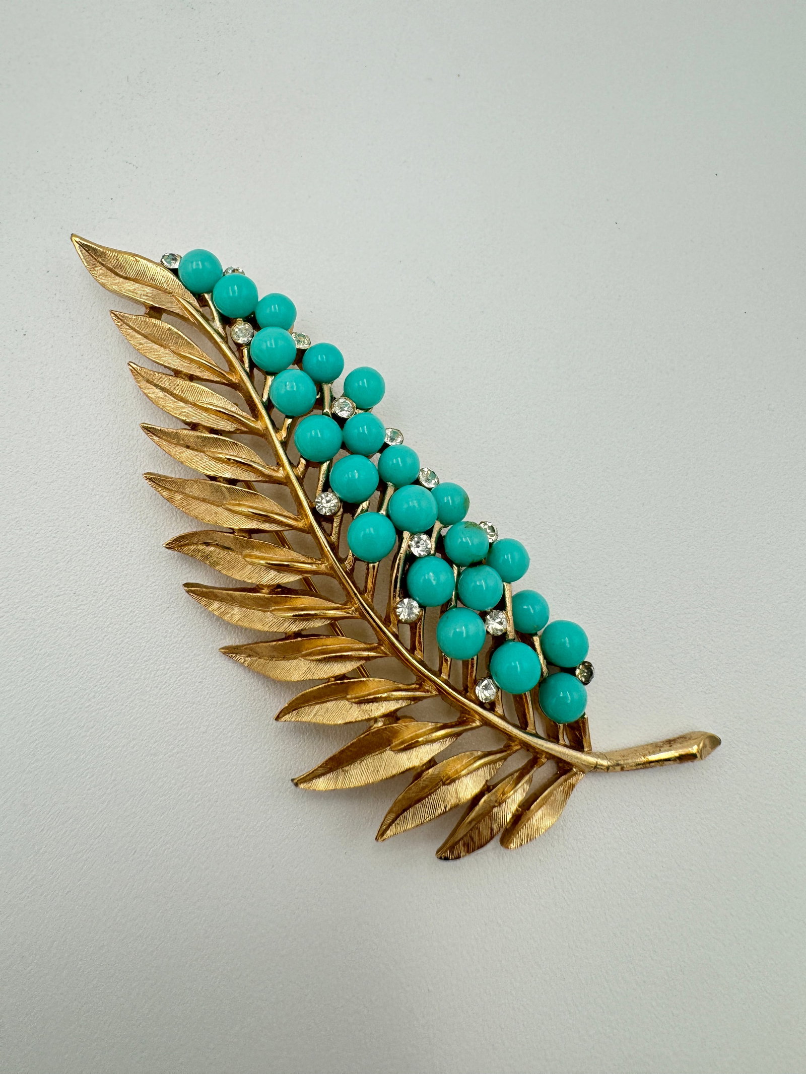 Vintage crown Trifari faux turquoise brooch 3” long: Vintage Crown Trifari faux turquoise brooch. Measuring 3 inches long. Sign on the back. Good vintage condition.See pictures for more details as they are the best description WE PROVIDE IN-HOUSE/COMBIN