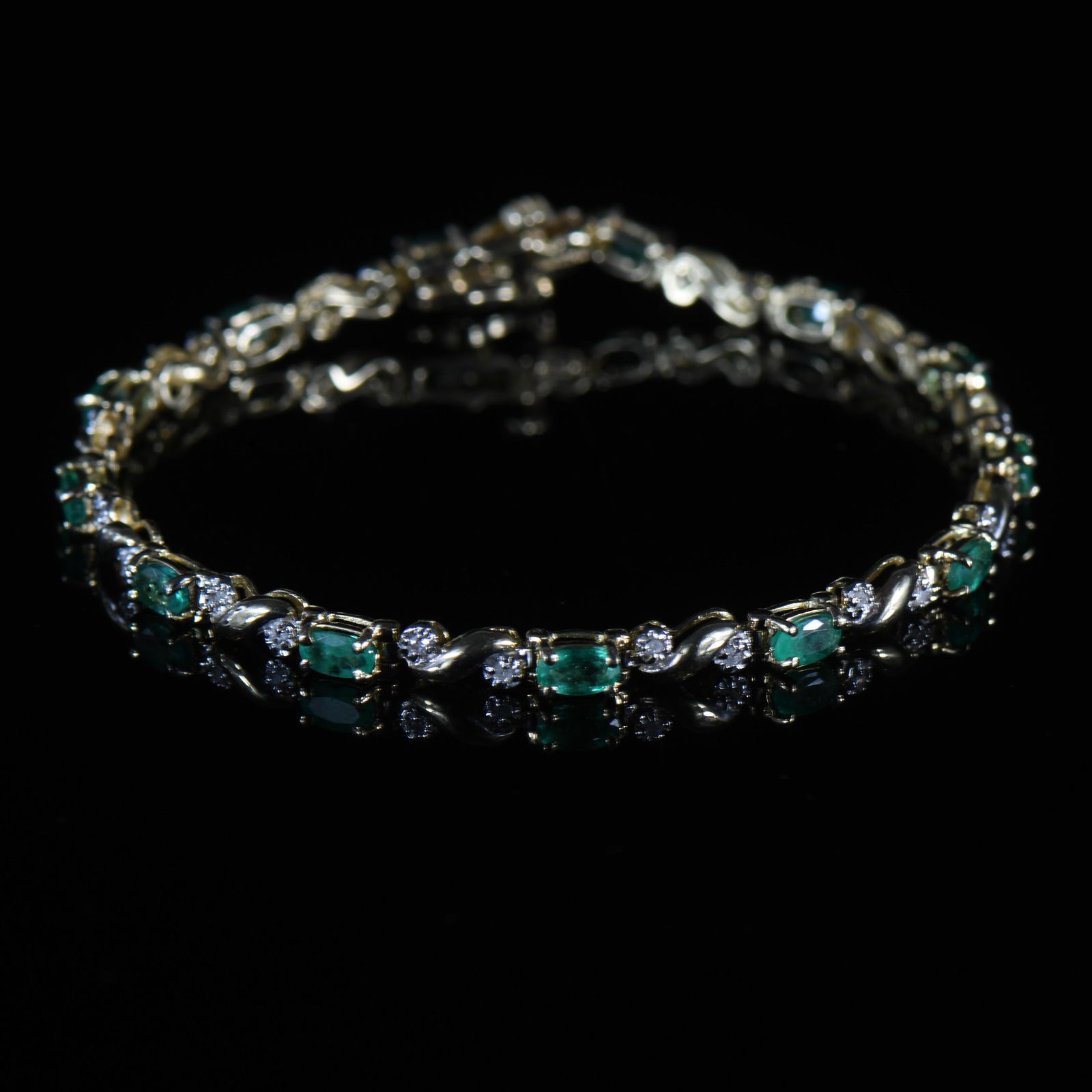 3.5ctw Emerald and Diamond 14K Yellow Gold Tennis Bracelet: Metal Type: 14K Yellow Gold (Tested) Weight: 8.10G Gold Melt Value: $398 Length: 7" Width: 3.43mm Thick: 3.65mm Clasp Type: Hallmarks: NISSKO NIS 14K Stone Details: Type: