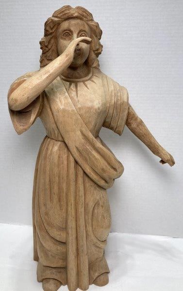Carved Figure of Woman: Woman in flowing robes and sash. Measures 19"T x 11"W. With repair to arm, missing thumb and trumpet. Shipping Available.