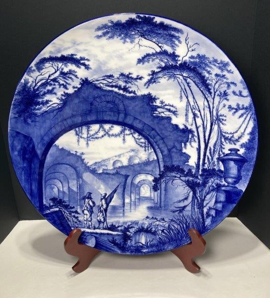 Antique Blue and White Charger: Blue and white landscape of ruins and Spanish soldiers. Makers mark of diamond with 977C on interior. Measures 20" diameter. In very good condition. Shipping Available.