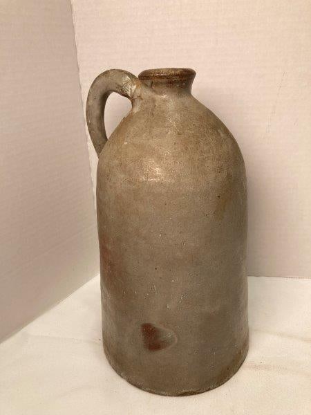 Upstate South Carolina Bell Shaped Jug: Jug attributed Whelchel with grayish glaze. Measures 10"T x 5 7/8" diameter at base. Handle has been reattached and has a small chip around base. Otherwise, in good condition. Shipping Available.