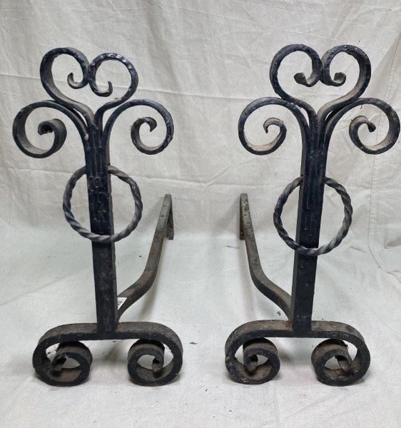 Pair of Decorative Arts & Crafts Wrought Iron Andirons: Black with handwrought and hammered scrollwork with rings. Measures 18 7/8"T x 9"W x 24 3/4"D. In very good condition. Shipping Available.