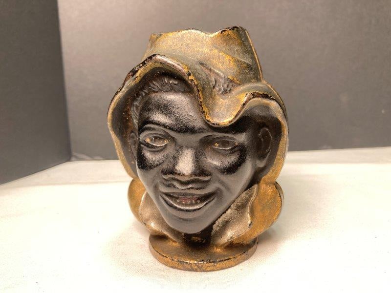 Black Americana Two-Faced Coin Still Bank: With gold, black and silver paint. Measures 4"T x 3"W x 3"D. In very good condition with light wear to finish. Shipping Available.