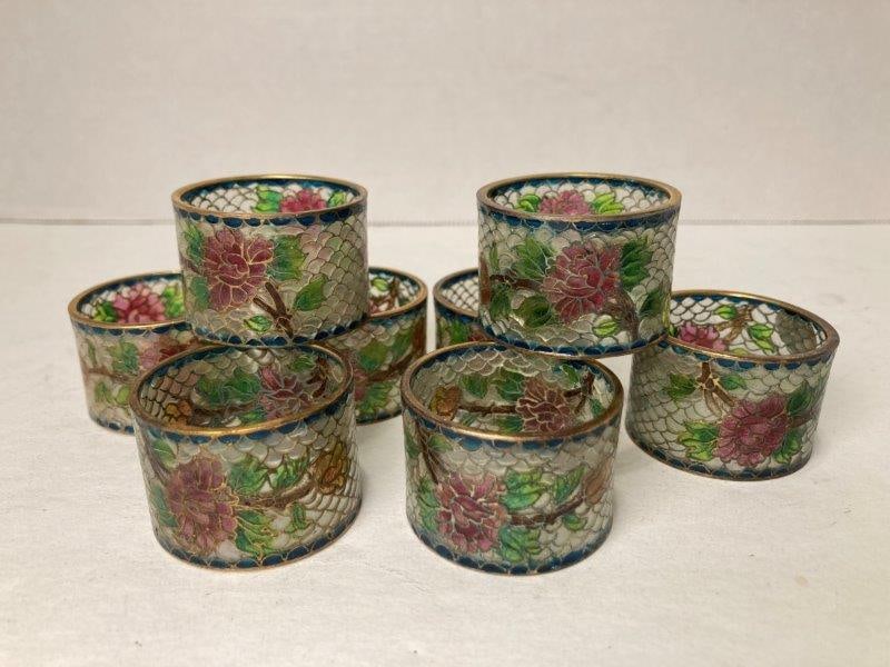 Eight Plique a Jour Napkin Rings: With floral design in blues, pinks and greens. Measures 1 1/4"T x 1 3/4"W. In good condition. Shipping Available.