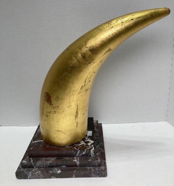 Gold Gilt Tusk On Marble Base: Faux tusk on marble base. Measures 14"T with a 8" Square base. With wear to gilt on tusk. Please refer to photos. Shipping Available.