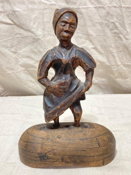 Folk Art Carved Woman Figure: Carved woman on wood base. Measures 15''T x 9''W. Some wear to finish. Shipping Available.
