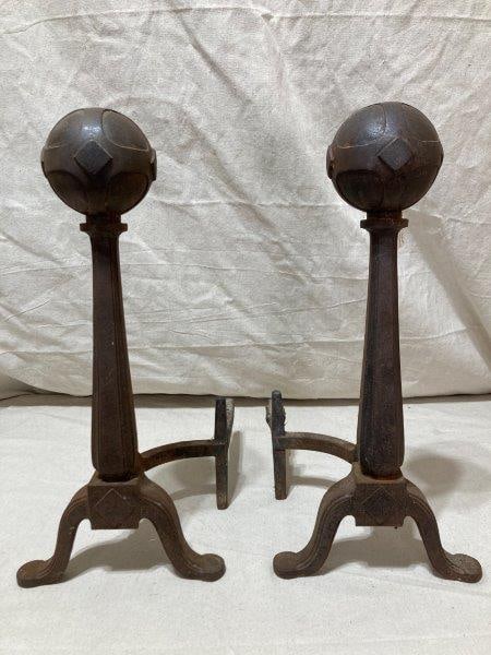 Arts and Crafts Andirons: This striking pair of Arts and Crafts andirons features a classic ball top design, complemented by elegantly tapered shafts. Measures 21''T x 10''W x 13''D. Finish has worn off. Shipping Available.