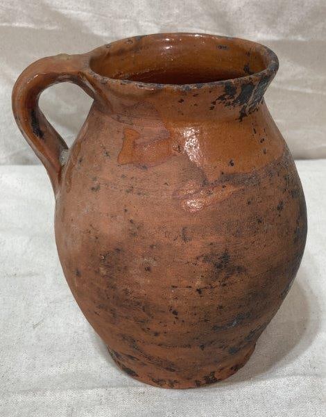 Redware Pitcher: Glaze to rim and handle. Measures 8''T. Some wear to the finish. Shipping Available.