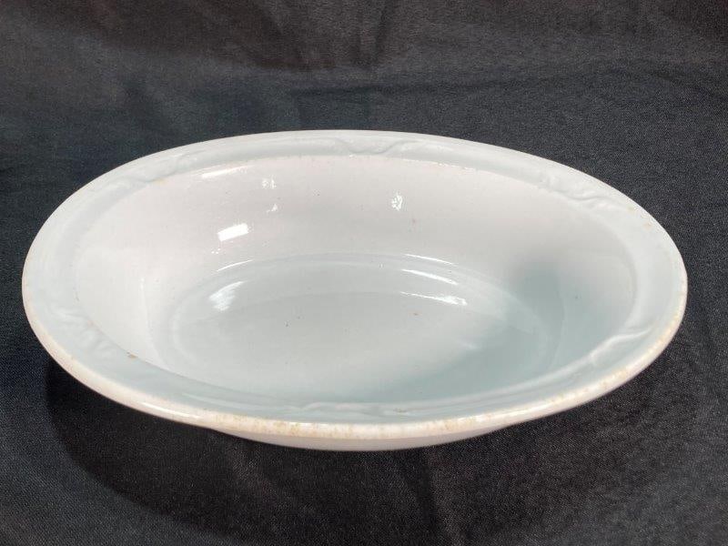 Ironstone Oval Serving Bowl: Oval shape with molded decoration on the rim. 2''T x 8''W x 10''. Good condition with some light discoloration and crazing.
