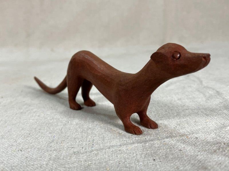 Folk Art Carved Weasel: Folk art carved weasel, whimsical sculpture depicting a weasel standing at attention. Measures 2''T x 3/4''W x 8''. Good condition.