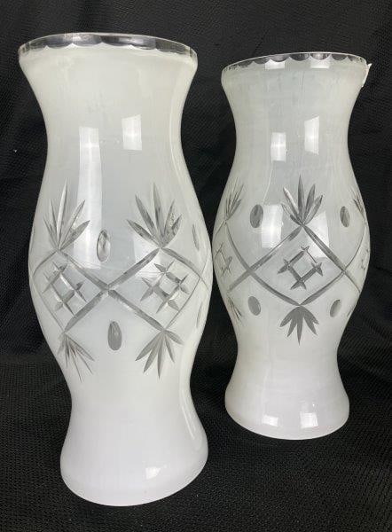 Pair of Cut-to-Clear Glass Hurricane Shades: Each finely crafted with starburst and hatchwork motifs, the overlay expertly cut to reveal intricate patterns in clear glass. Each measures 13"H x 5"W. In good condition. Shipping Available.