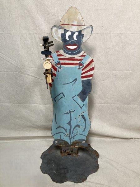 Black Americana Sprinkling Sambo: Cast in metal with red, white, and blue paint. Measures approx. 36''T x 15'' round at base. Some rust and fading to paint. Shipping Available.