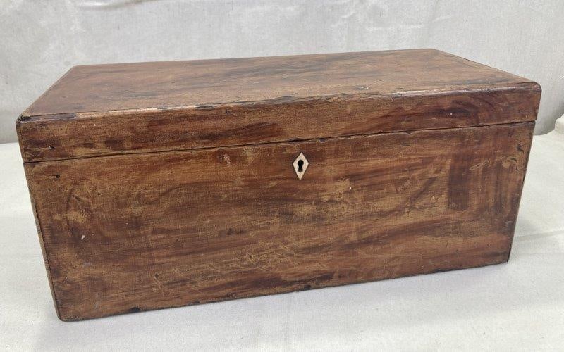 Grain-Painted Miniature Chest: This charming miniature chest features a skillfully executed grain-painted surface and a bone inlaid escutcheon. Measures approx. 7 1/4''T x 17''W x 8''D. Good condition with some loss to the finish. 