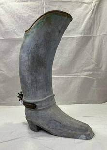 Metal Boot Umbrella Stand: Whimsical metal umbrella stand in the form of a riding boot, complete with a sculpted spur detail. Measures approx. 22 3/4''H x 7 1/2''W x 17''D. Some wear to the finish. Shipping available. 
