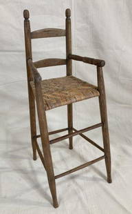 Fine Southern High Chair: Well-crafted example in yellow pine featuring finely turned finials, slightly shaped splats and arms, and a woven river cane seat. Displays classic Southern form with graceful proportions and warm