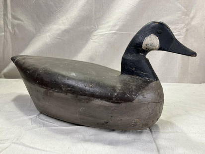 Antique Canadian Goose Decoy: Early hollow-body decoy with well-worn painted surface and strong form, possibly originating from Virginia. Displays age-appropriate wear with some loss to the neck and surface finish. Measures
