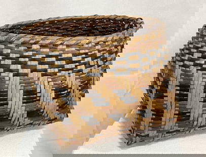 Cherokee Rivercane Basket: Traditional handwoven form using natural bloodroot and walnut dyes, showcasing a striking and well-balanced design. Measures approx. 7 1/4''T x 10'' in diameter. Good condition with light wear. 
