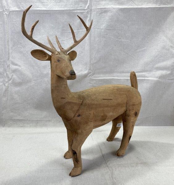 Carved Folk Art Buck with Applied Antlers: Expressive folk art carving of a buck featuring a detailed, slightly grinning expression and finely crafted applied antlers. Measures approx. 19''H x 19''W x 4''D. Good condition with light wear to th