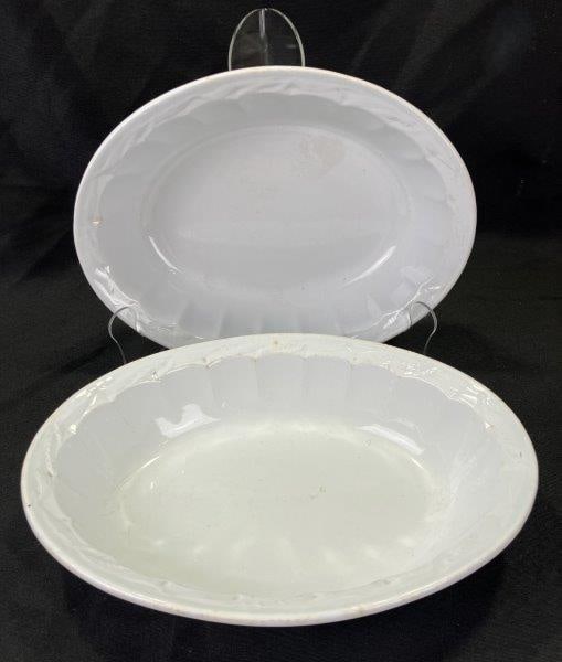 Pair of Turner Goddard Ironstone Oval Bowls: Elegant pair of oval ironstone bowls by Turner Goddard, each featuring faceted inner sides that add refined texture and visual interest. Classic white glaze with age-appropriate crazing and light scuf
