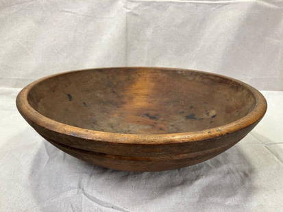 Turned Primitive Dough Bowl: Well-proportioned early bowl with a timeworn surface and rich patina. Hand-turned with visible tool marks and age character. Measures approximately 4''H x 15'' in diameter. Shipping available. 