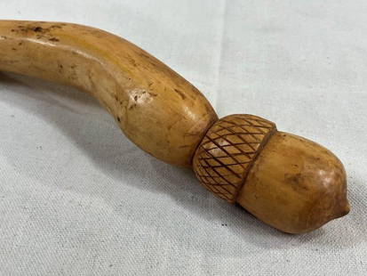 Folk Art Carved Cane with Acorn Handle: Charming folk art cane featuring a carved acorn-shaped handle and a thick shaft adorned with intricately carved acorns and leaves. Measures approx. 41''L. Small split in the handle. Shipping