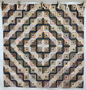 Handmade Log Cabin Quilt in Barn Raising Arrangement: Composed of countless fabric strips in a wide array of colors and textures, this classic Log Cabin quilt is arranged in the traditional Barn Raising layout, with blocks radiating outward to form a