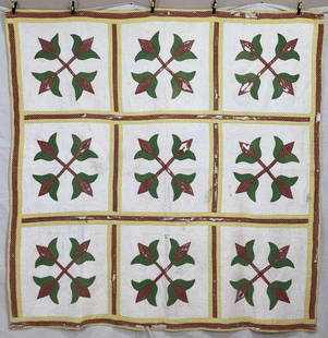 Handmade Appliqued Tulip Quilt: Featuring a repeating floral design in patterned red and green fabrics, this finely hand-appliquéd quilt is set against a crisp white ground, highlighting the vibrant botanical forms. The