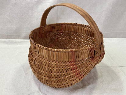 Split Oak Buttocks Gathering Basket: Finely woven split oak buttocks gathering basket featuring a classic, well-balanced form and tightly constructed weave. Measures approx. 9''H x 9 3/8''W x 9 5/8''D. Good condition. Shipping
