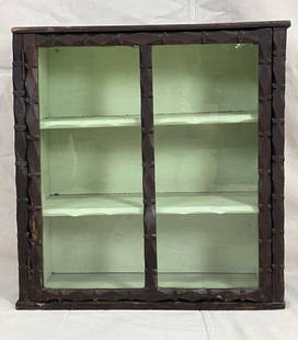 Tramp Art Wall Cabinet: Charming folk art wall cabinet featuring layered carved trim and a glass panel door. Retains a nicely worn original surface with rich patina. A fine example of tramp art craftsmanship. Measures