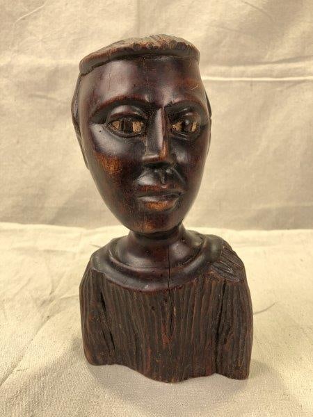 Folk Art Carved African American Bust: Finely detailed hand-carved bust with expressive eyes and a rich dark finish. A powerful and emotive folk art piece. Measures approximately 8''H x 4''W x 2 1/2''D. Good condition with minor surface we