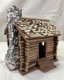 Folk Art Miniature Cabin: Charming handcrafted cabin featuring small log construction and a stone chimney. Detailed folk art example with a rustic feel. Measures approximately 9''H x 8 1/4''W x 7''D. Good condition with some